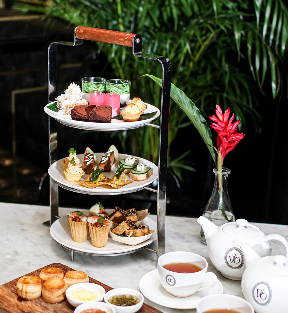 Unwind with Violet Oon's high tea: a charming 3-tiered platter showcasing a delightful mix of sweet & savoury treats!