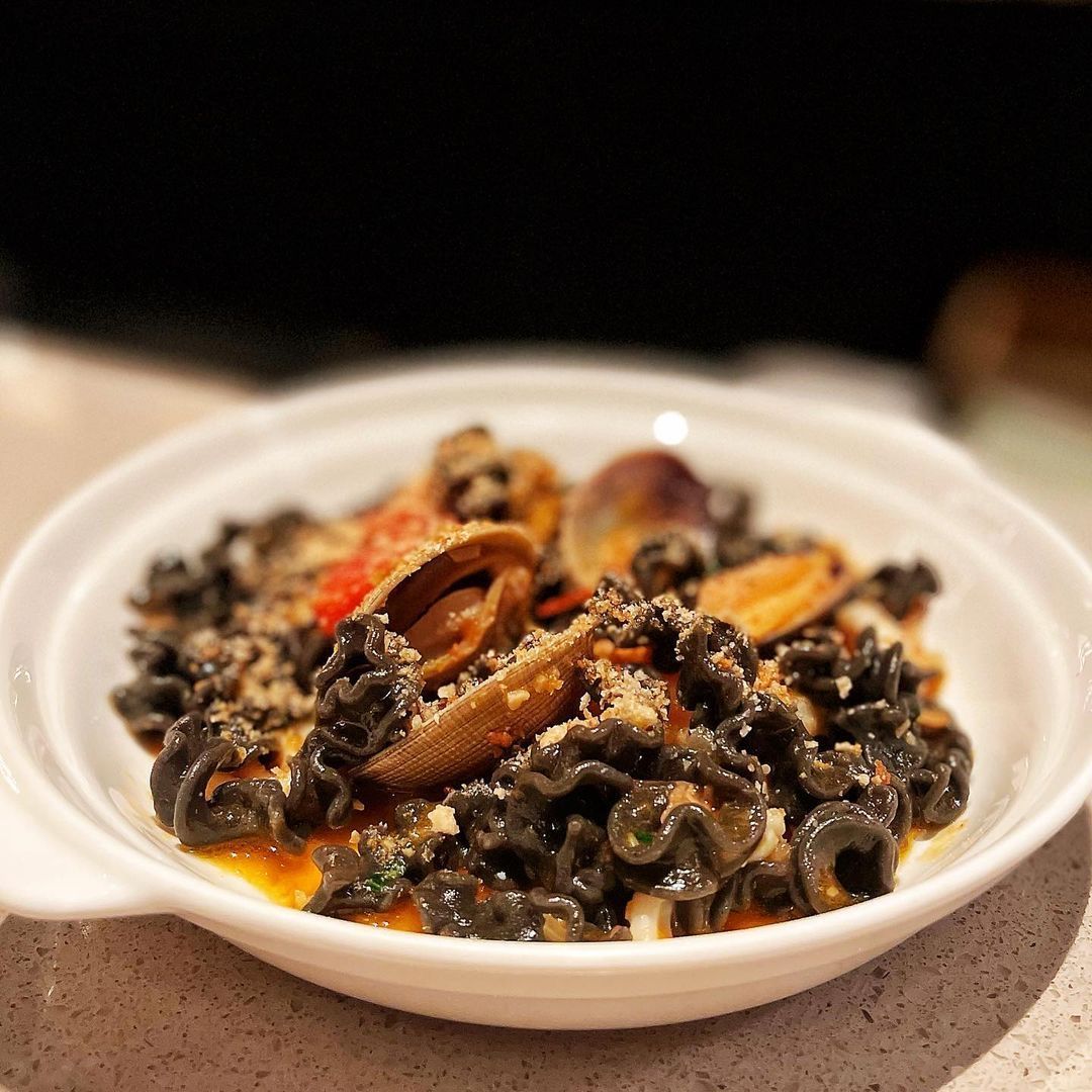 Indulge in a luxurious seafood experience with this inky masterpiece.