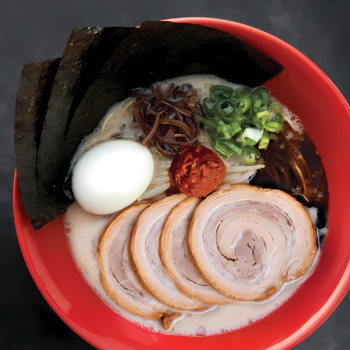 Savour the fiery goodness of Akamaru Shinaji, featuring springy noodles and tender pork belly chashu.